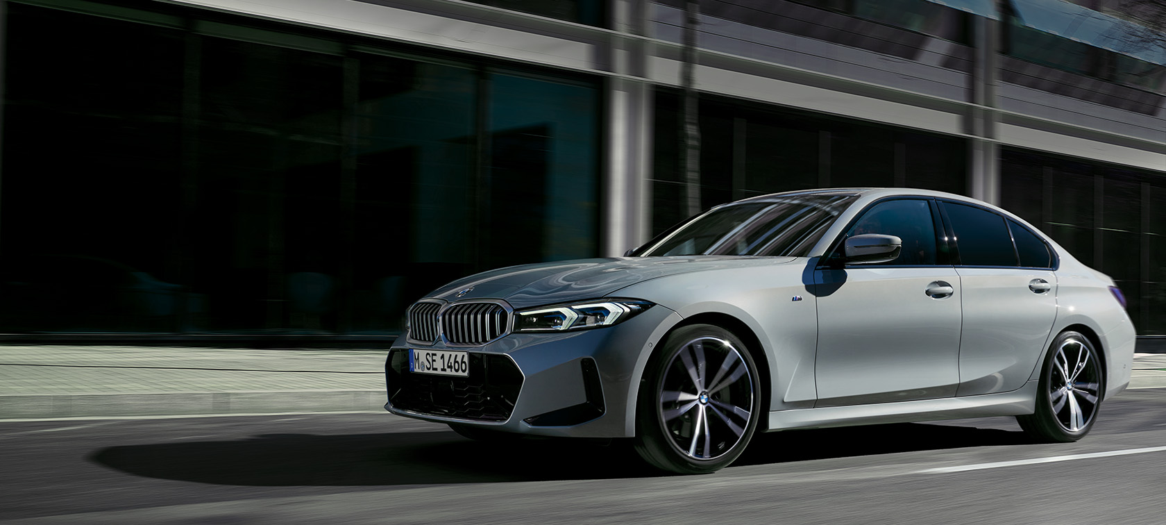 BMW 3 Series Sedan LCI G20 Brookly Grey side view standing in front of wall