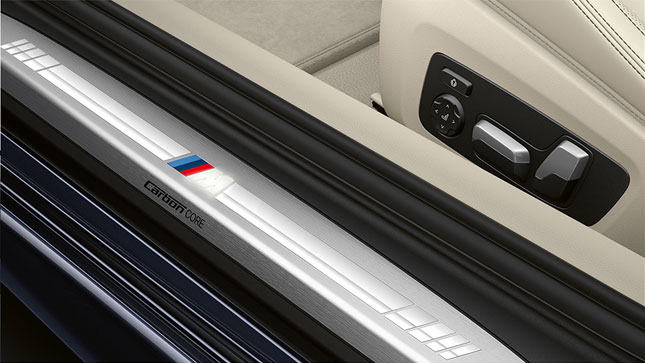 Close-up of the door sill of the BMW 8 Series Coupé with M logo.