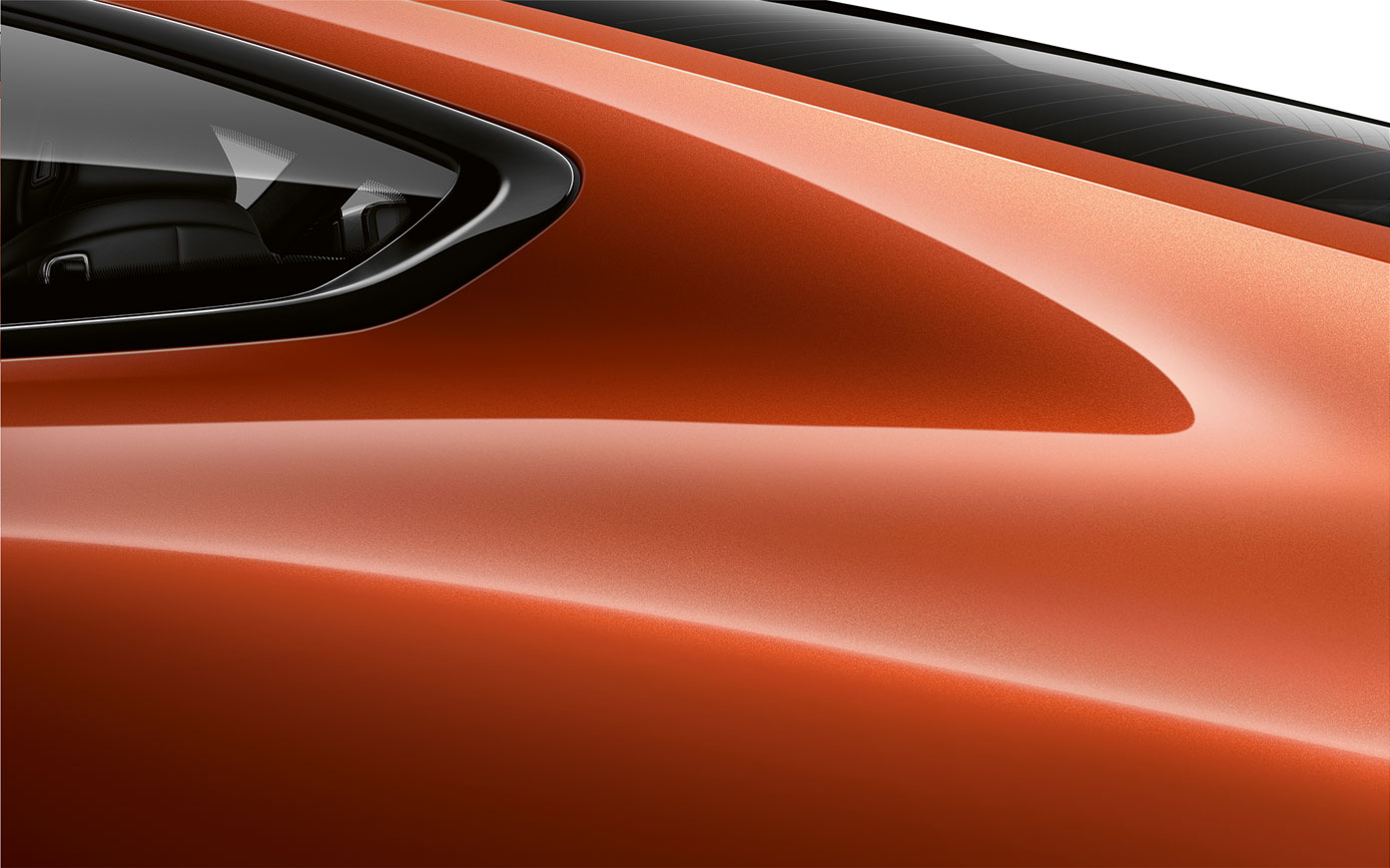 Close-up of the C pillar of the BMW 8 Series Coupé in Sunset Orange metallic.