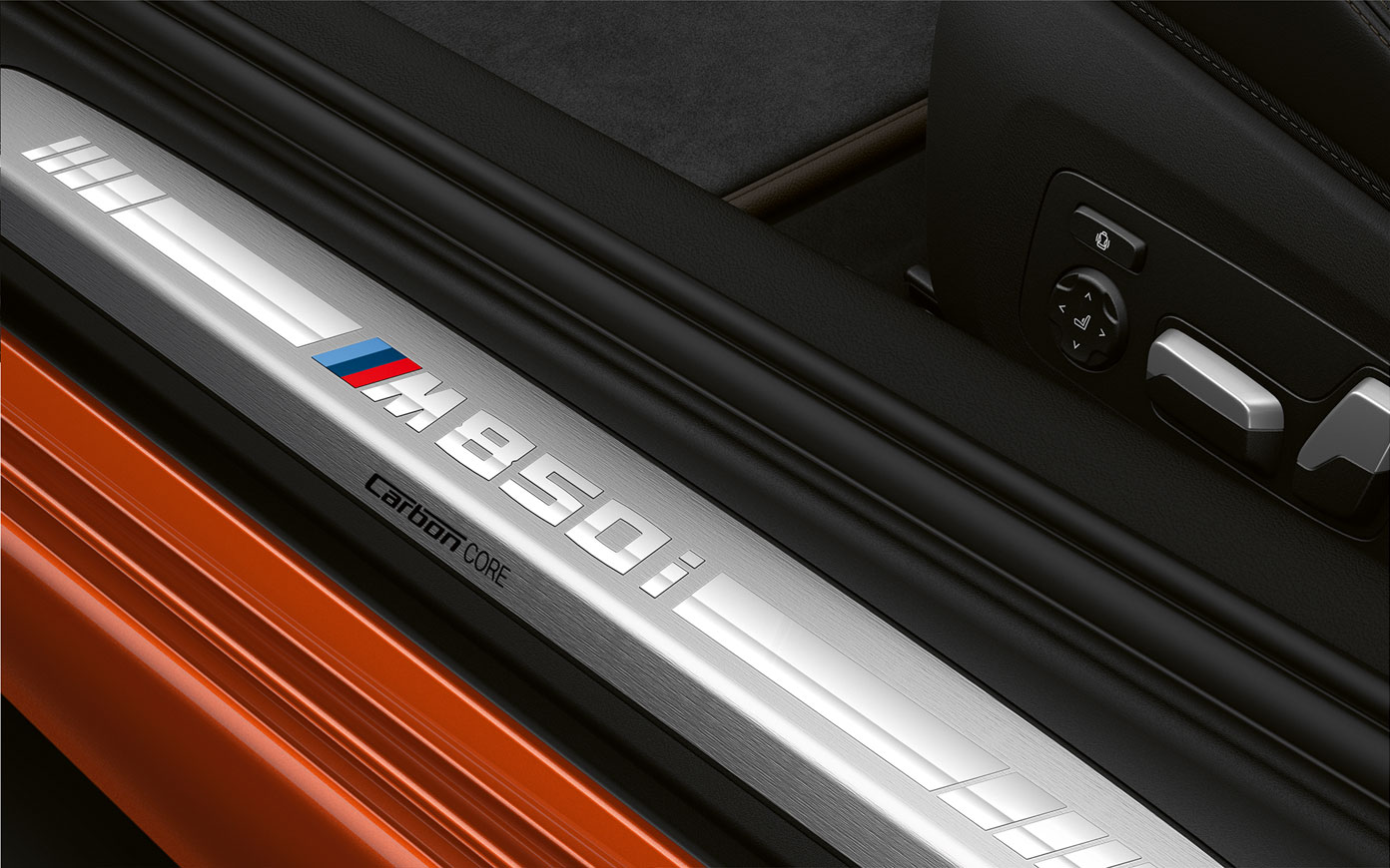 Close-up of the door sill of the BMW 8 Series Coupé with M850i logo.