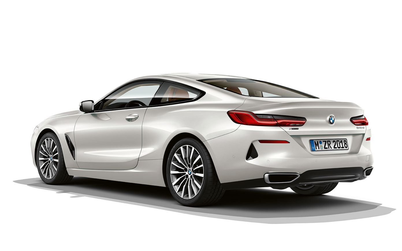 Still shot of the BMW 8 Series Coupé in Mineral White metallic against a white background.